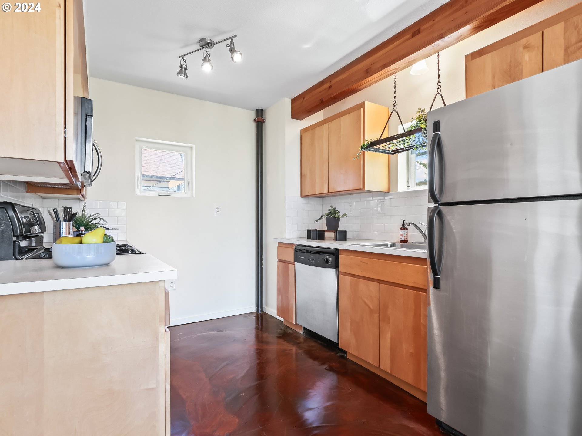 2021 Southeast Clinton Street, Unit 201 Portland, OR 97202 - Photo 11 of 35 a kitchen with stainless steel appliances a refrigerator sink and white cabinets