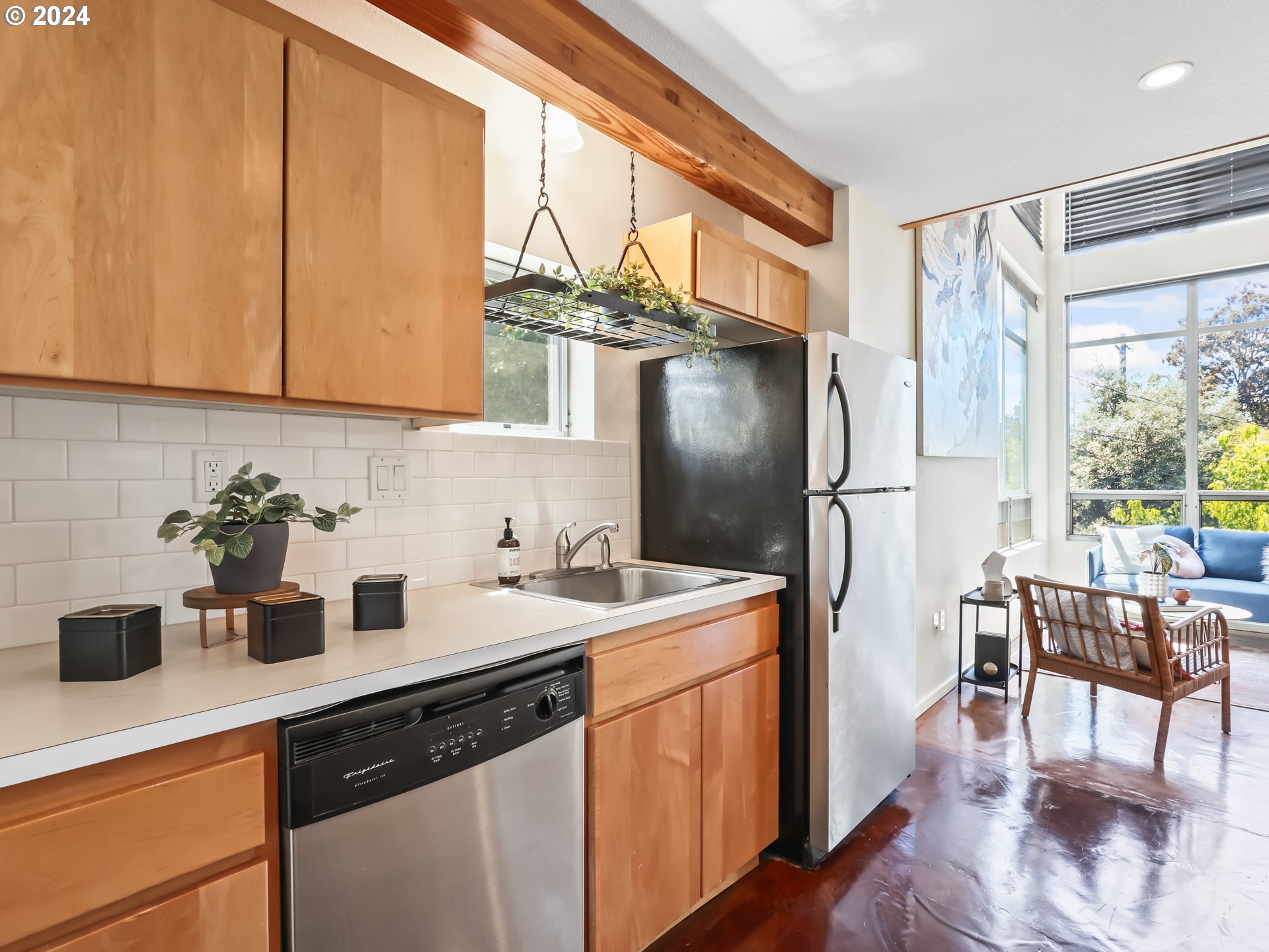 2021 Southeast Clinton Street, Unit 201 Portland, OR 97202 - Photo 12 of 35 a kitchen with a sink a refrigerator and cabinets