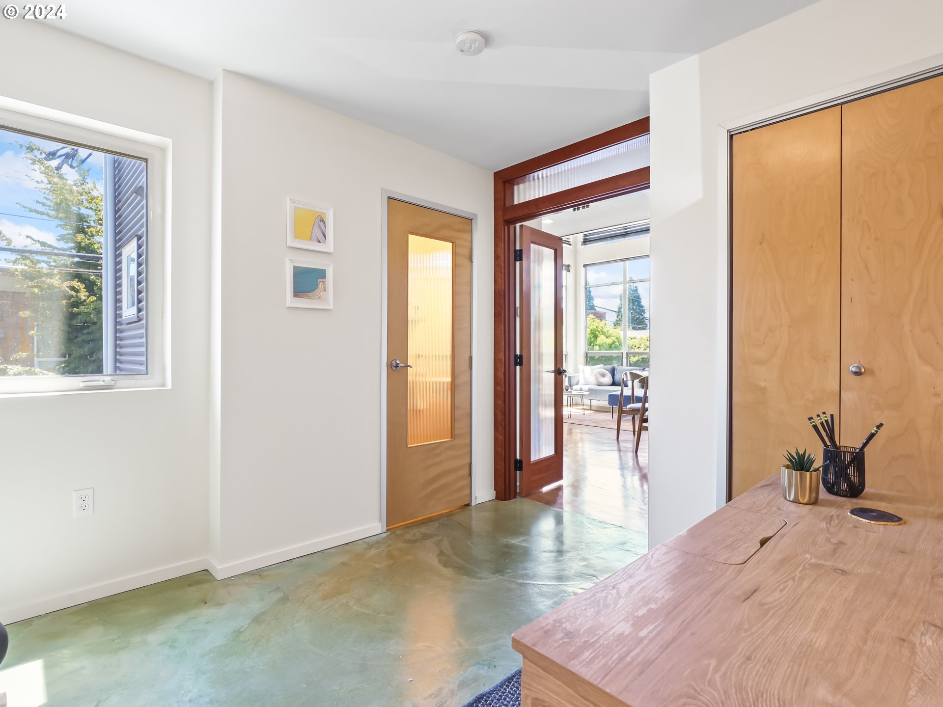 2021 Southeast Clinton Street, Unit 201 Portland, OR 97202 - Photo 16 of 35 a bedroom with a bed and wooden floor