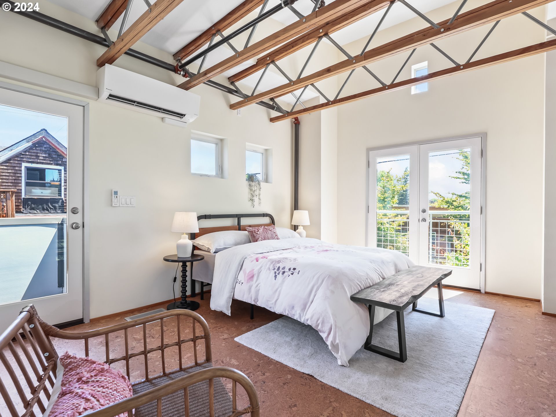 2021 Southeast Clinton Street, Unit 201 Portland, OR 97202 - Photo 20 of 35 a bed sitting in a bedroom next to a window