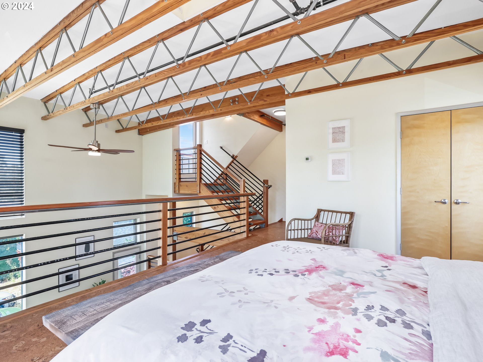 2021 Southeast Clinton Street, Unit 201 Portland, OR 97202 - Photo 22 of 35 a bedroom with a bed and wooden floor