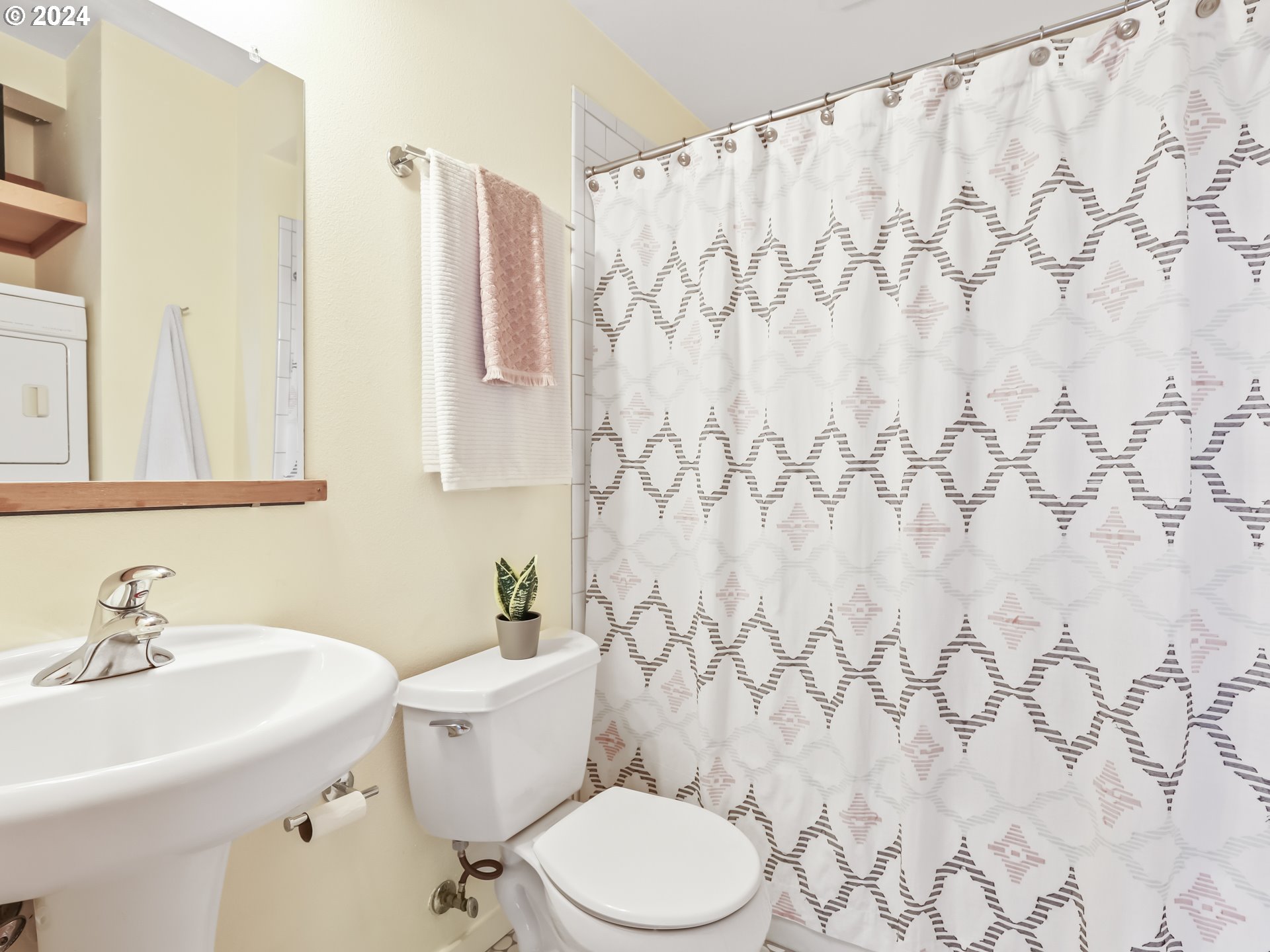 2021 Southeast Clinton Street, Unit 201 Portland, OR 97202 - Photo 23 of 35 a bathroom with a sink toilet and a mirror