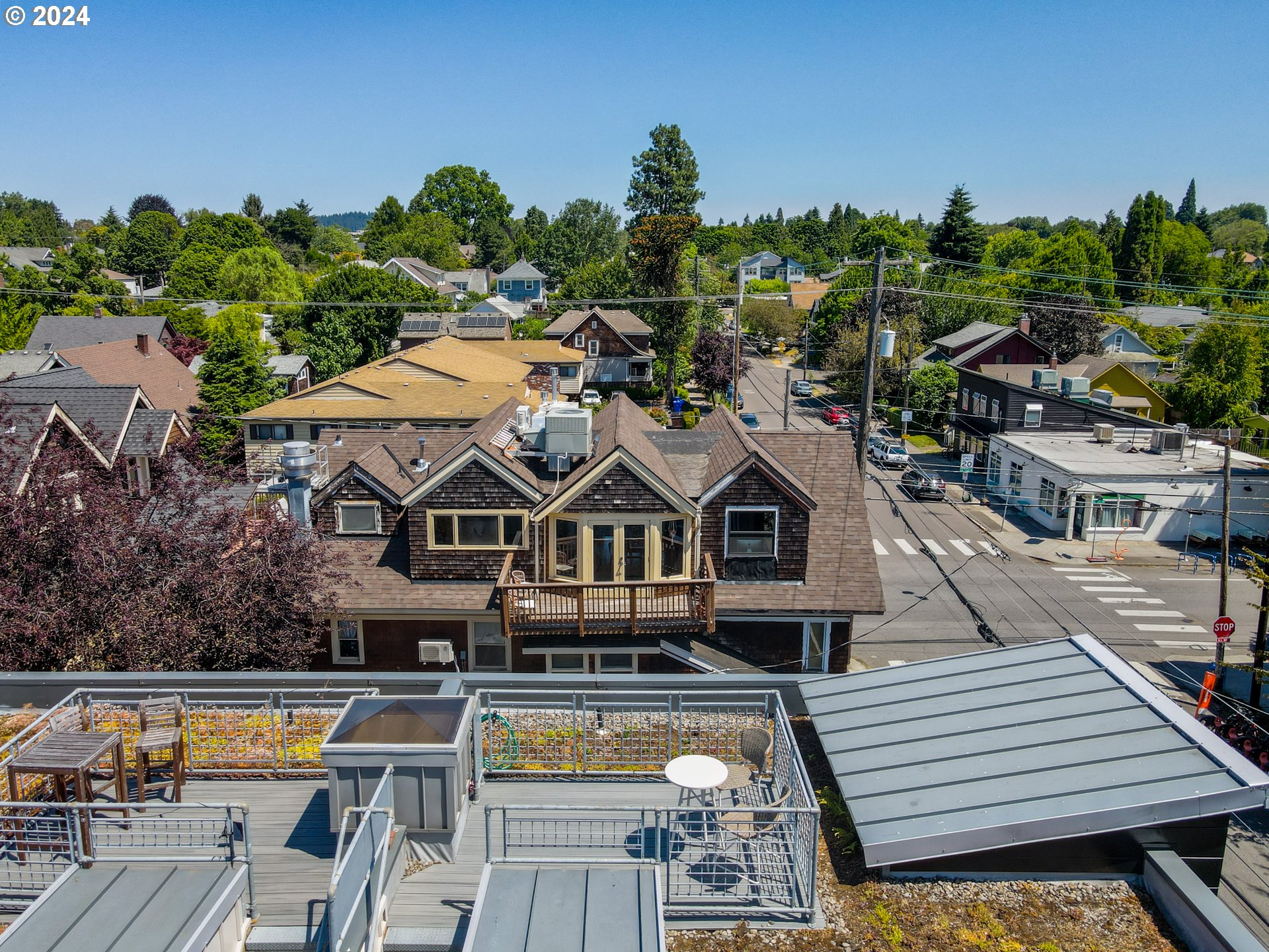 2021 Southeast Clinton Street, Unit 201 Portland, OR 97202 - Photo 29 of 35 an aerial view of a house with swimming pool and large trees