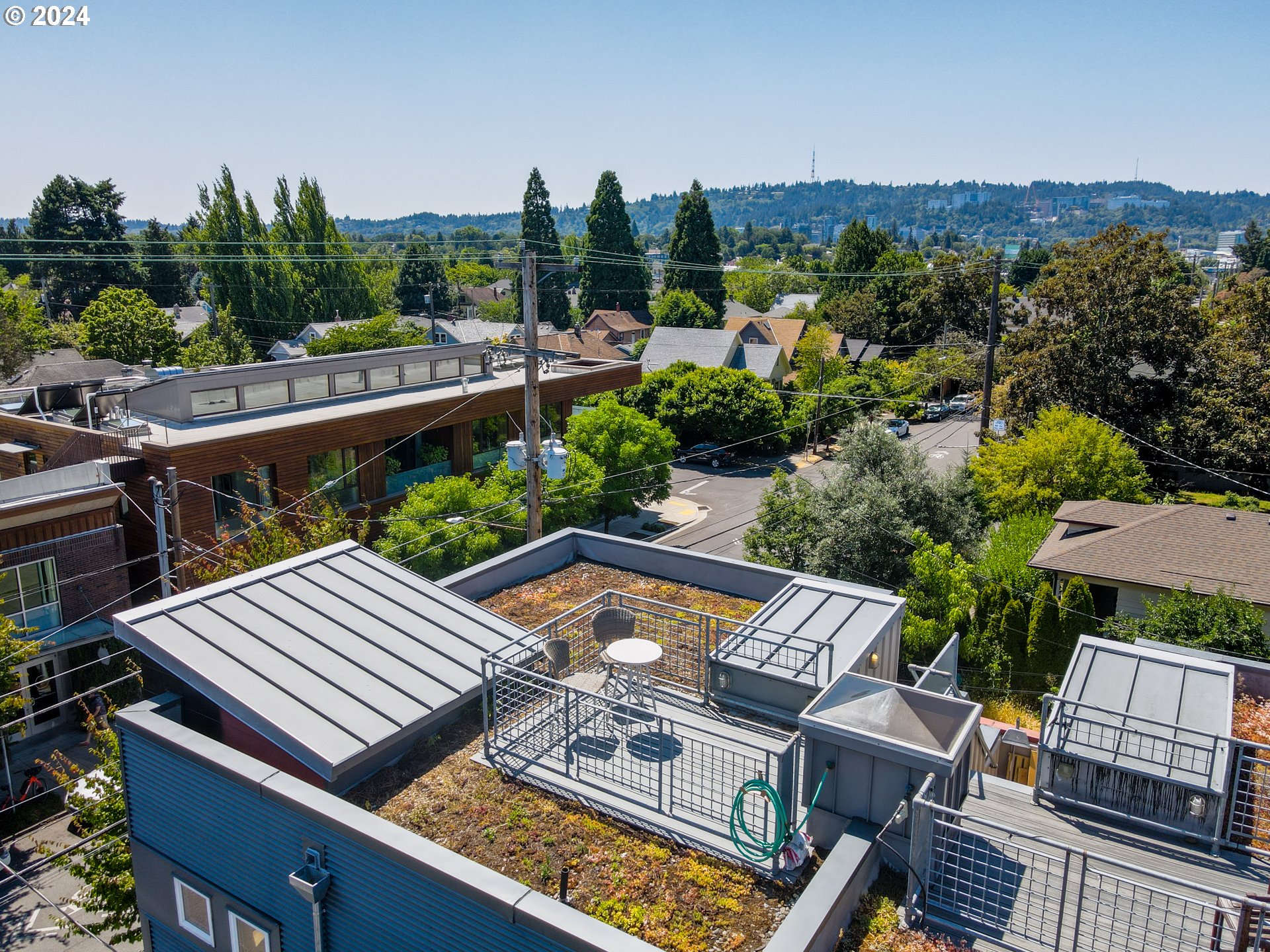 2021 Southeast Clinton Street, Unit 201 Portland, OR 97202 - Photo 32 of 35 a view of a patio with chairs and a table