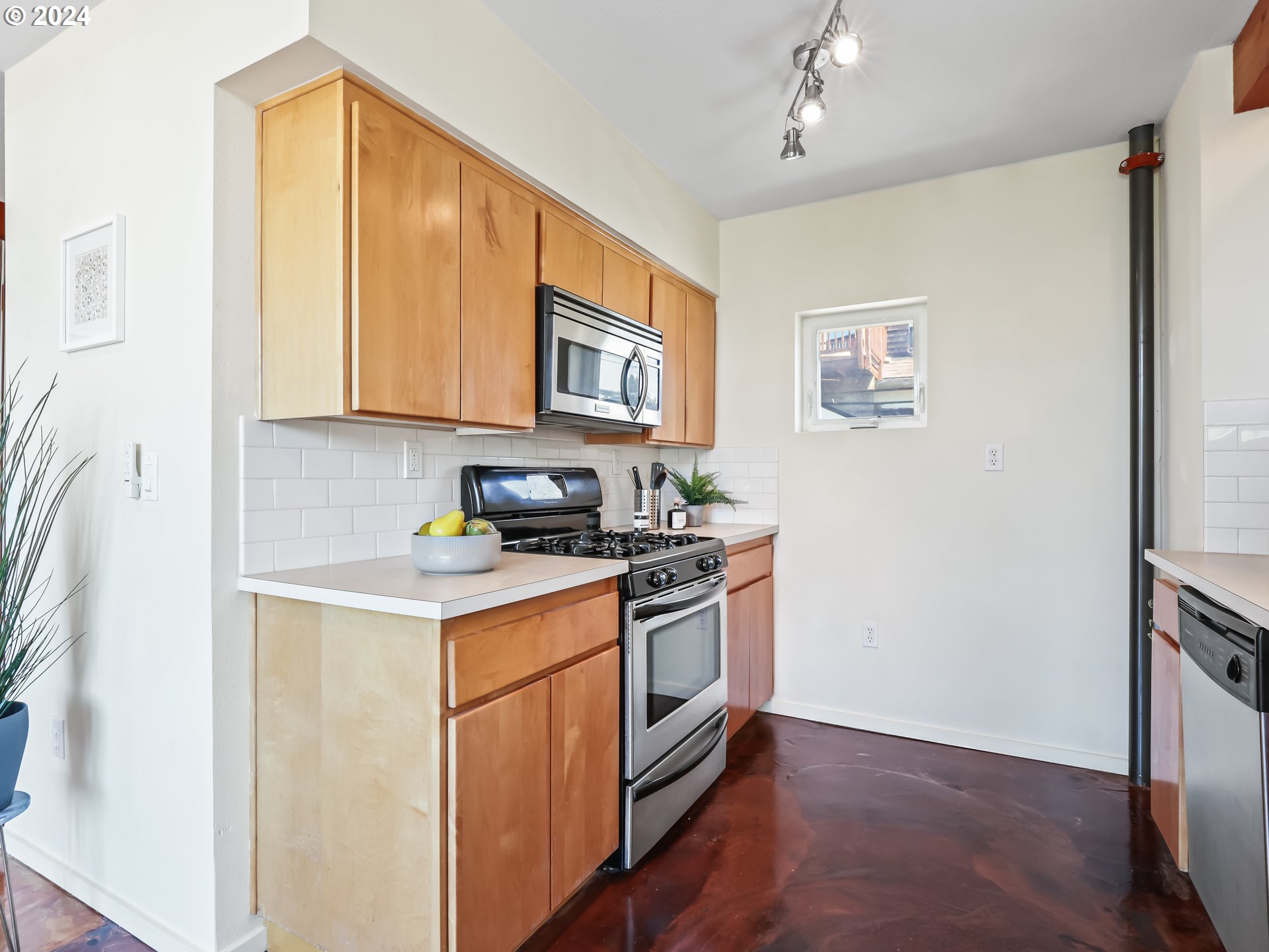 2021 Southeast Clinton Street, Unit 201 Portland, OR 97202 - Photo 10 of 35 a kitchen with stainless steel appliances granite countertop a stove and a refrigerator
