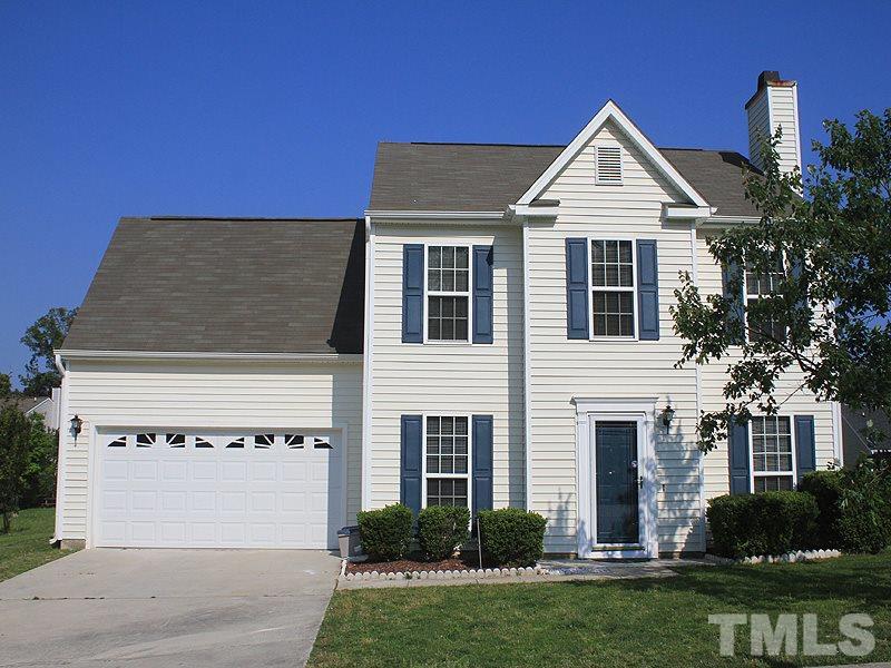 5201 Cardinal Grove Boulevard Raleigh, NC 27616 - Photo 1 of 14 a front view of a house with a yard and garage