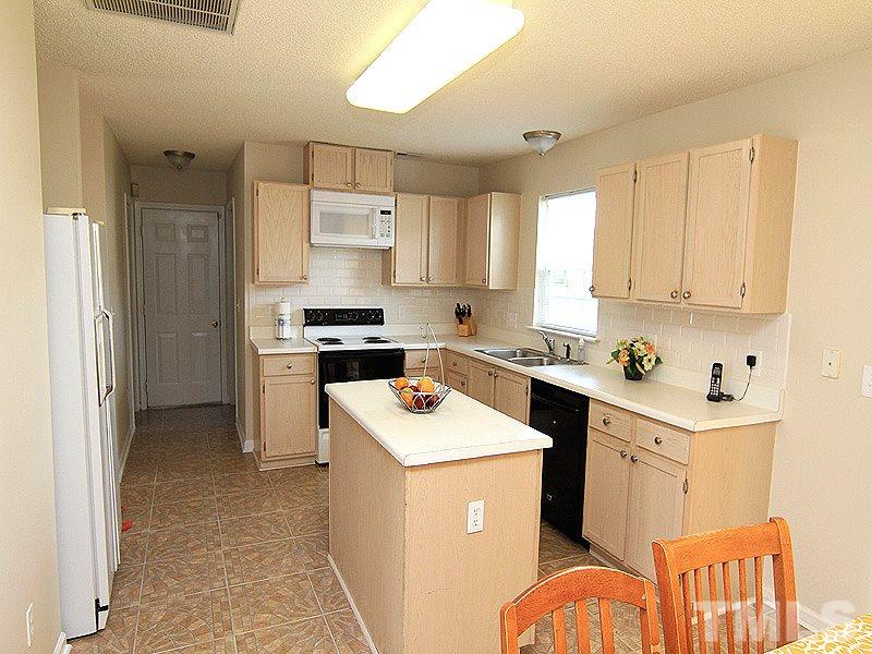 5201 Cardinal Grove Boulevard Raleigh, NC 27616 - Photo 4 of 14 a kitchen with stainless steel appliances granite countertop a sink stove and refrigerator