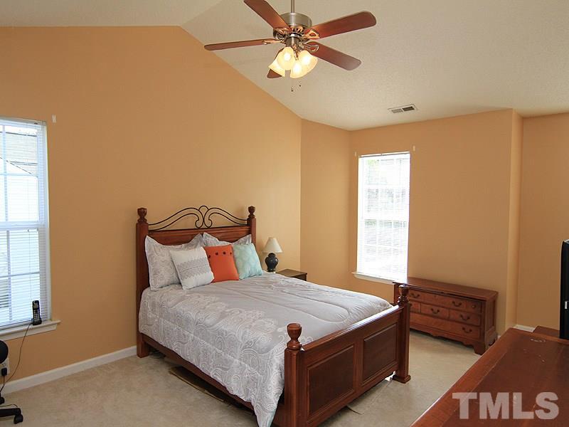 5201 Cardinal Grove Boulevard Raleigh, NC 27616 - Photo 6 of 14 a bedroom with a bed and a chandelier