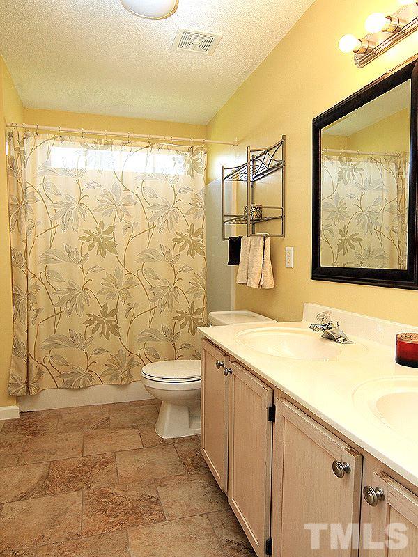 5201 Cardinal Grove Boulevard Raleigh, NC 27616 - Photo 8 of 14 a bathroom with a sink toilet and shower