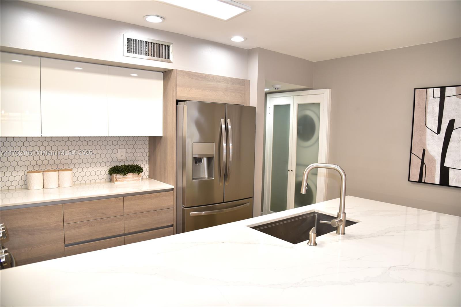6435 Windmill Gate Road Miami Lakes, FL 33014 - Photo 8 of 29 a bathroom with a sink and a large mirror