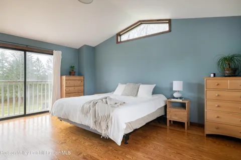 a bedroom with a bed and a large window