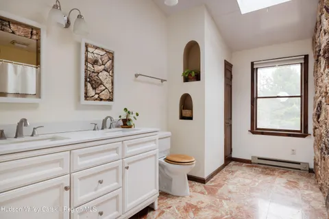a bathroom with a toilet sink and mirror