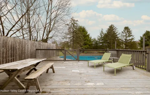 a view of a chairs and table on the deck