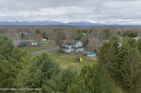a view of a big yard with a house in the background