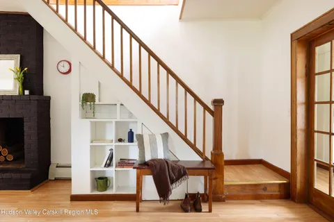 a view of entryway and hall with wooden floor