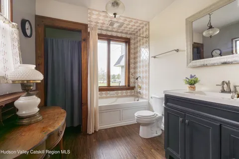 a bathroom with a toilet sink and mirror