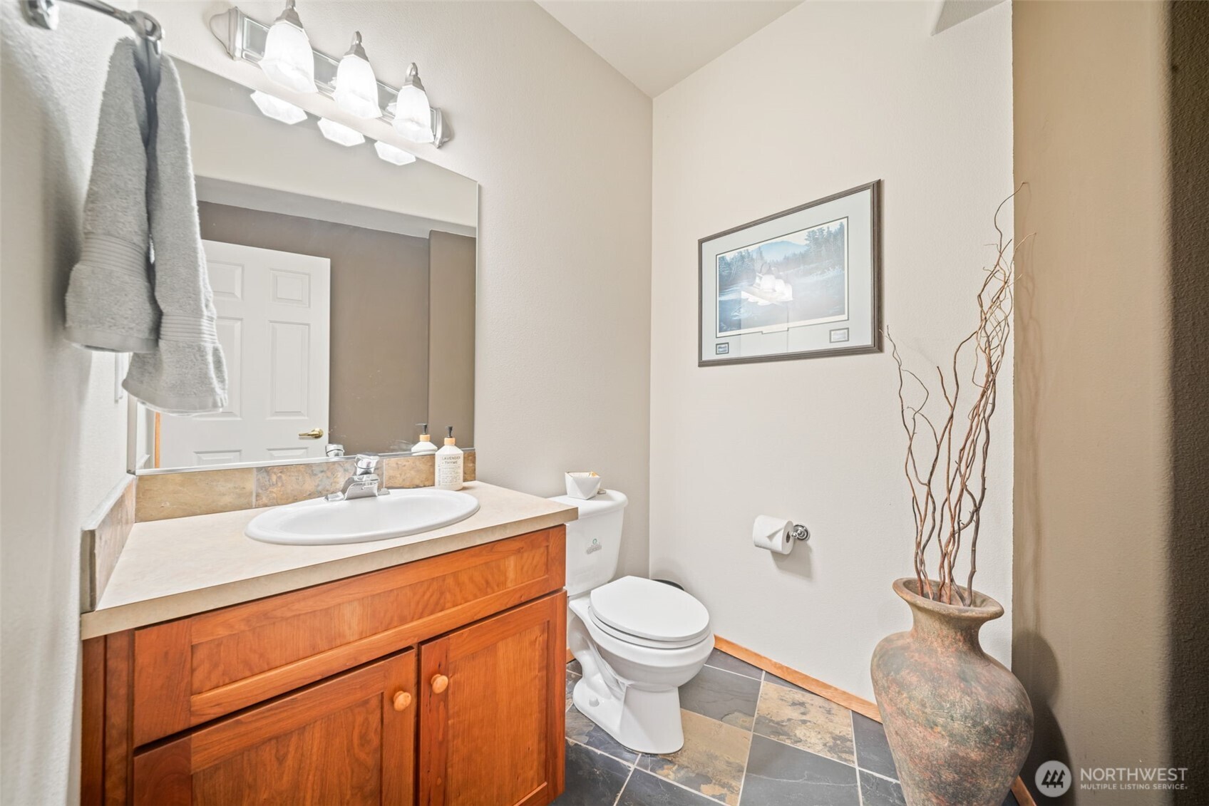 813 Varsity Road Kalama, WA 98625 - Photo 31 of 40 a bathroom with a toilet a sink and mirror