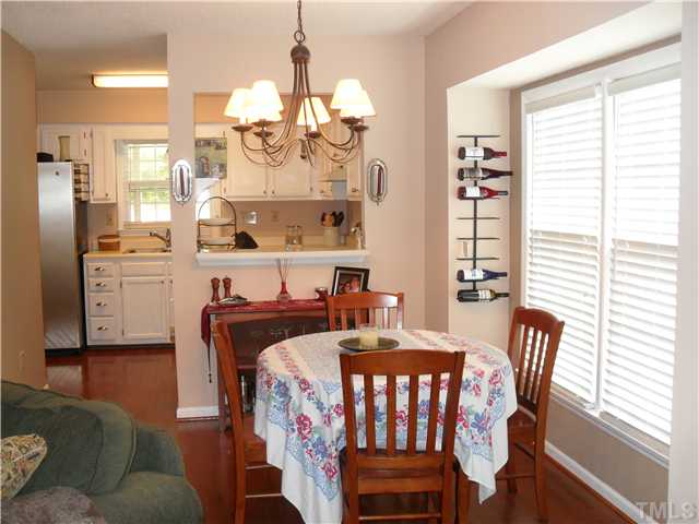 Lots of Light Shine Through Picture Window In The Dinning Area. Bar and Pass Through To The Kitchen. Opens to The Living Room.