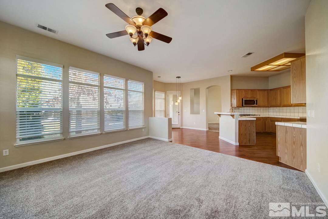 1565 Diamond Country Drive Reno, NV 89521 - Photo 16 of 30 a view of an empty room with a kitchen counter and a window