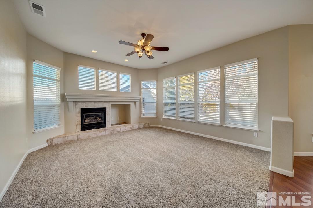 1565 Diamond Country Drive Reno, NV 89521 - Photo 5 of 30 a view of an empty room with a fireplace and a window