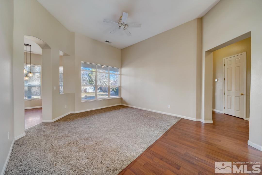 1565 Diamond Country Drive Reno, NV 89521 - Photo 8 of 30 a view of an empty room with window and wooden floor