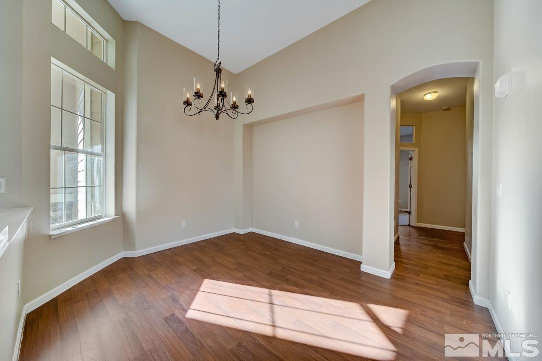 1565 Diamond Country Drive Reno, NV 89521 - Photo 9 of 30 wooden floor in an empty room with a window