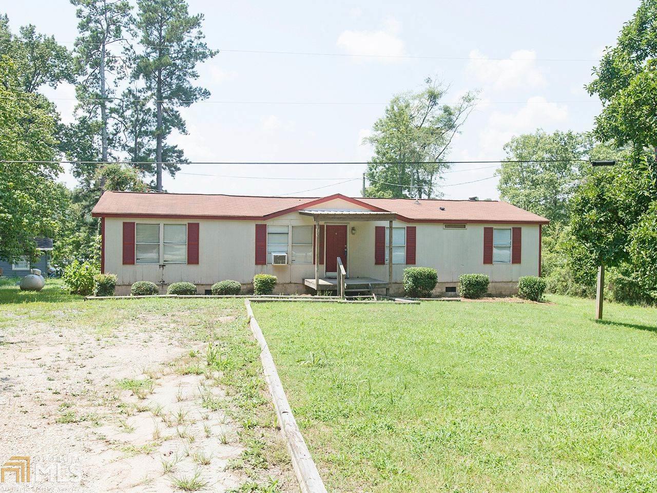 171 Weavers Lakefront Road Jackson, GA 30233 - Photo 1 of 1 a front view of a house with a yard and trees
