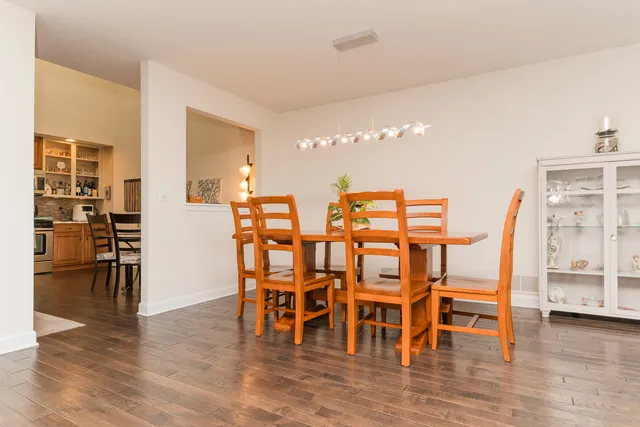 a dining room with furniture wooden floor and windows