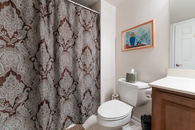a white toilet sitting next to a bathroom sink