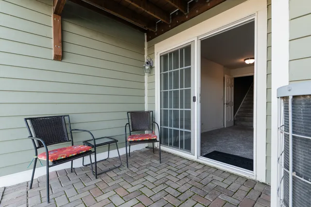 a view of a room with table and chairs