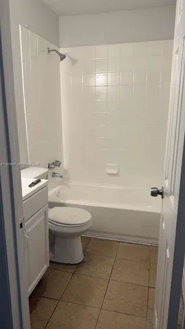 a bathroom with a toilet sink and shower