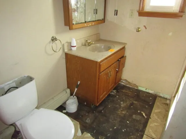 a bathroom with a sink a toilet and mirror