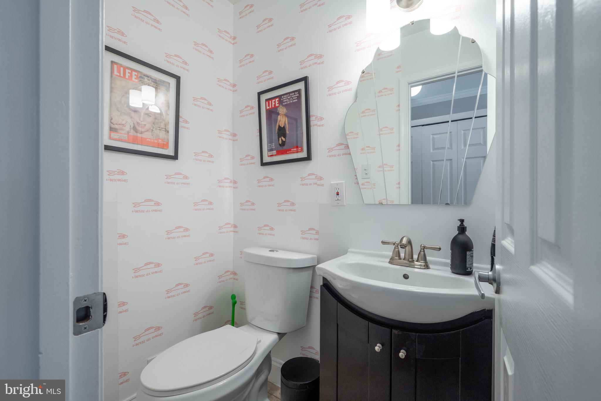 352 N Street Southwest Washington, DC 20024 - Photo 15 of 57 a bathroom with a toilet sink and mirror