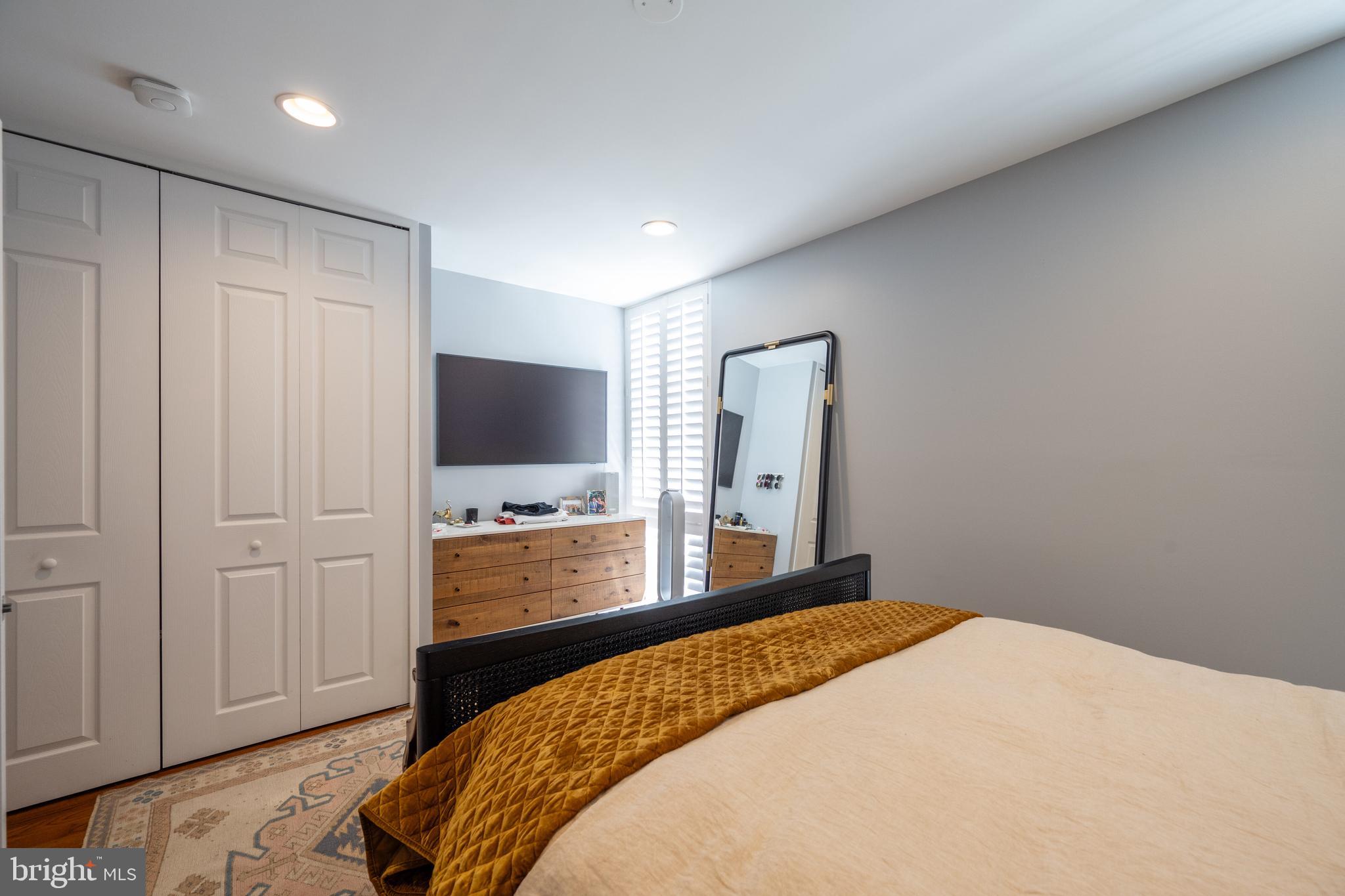 352 N Street Southwest Washington, DC 20024 - Photo 19 of 57 a bedroom with a bed and a flat screen tv