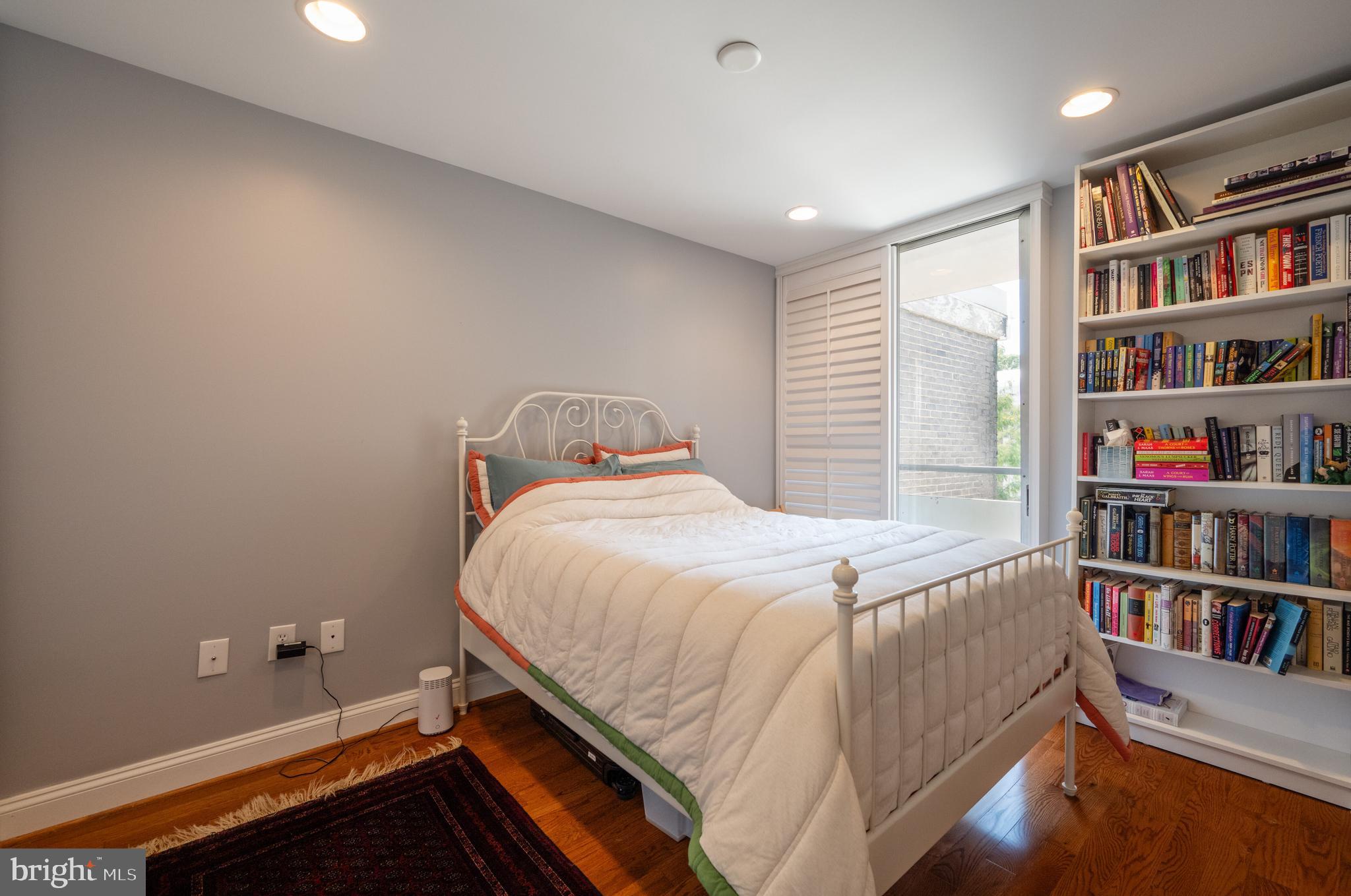352 N Street Southwest Washington, DC 20024 - Photo 21 of 57 a bed sitting in a bedroom next to a book shelf