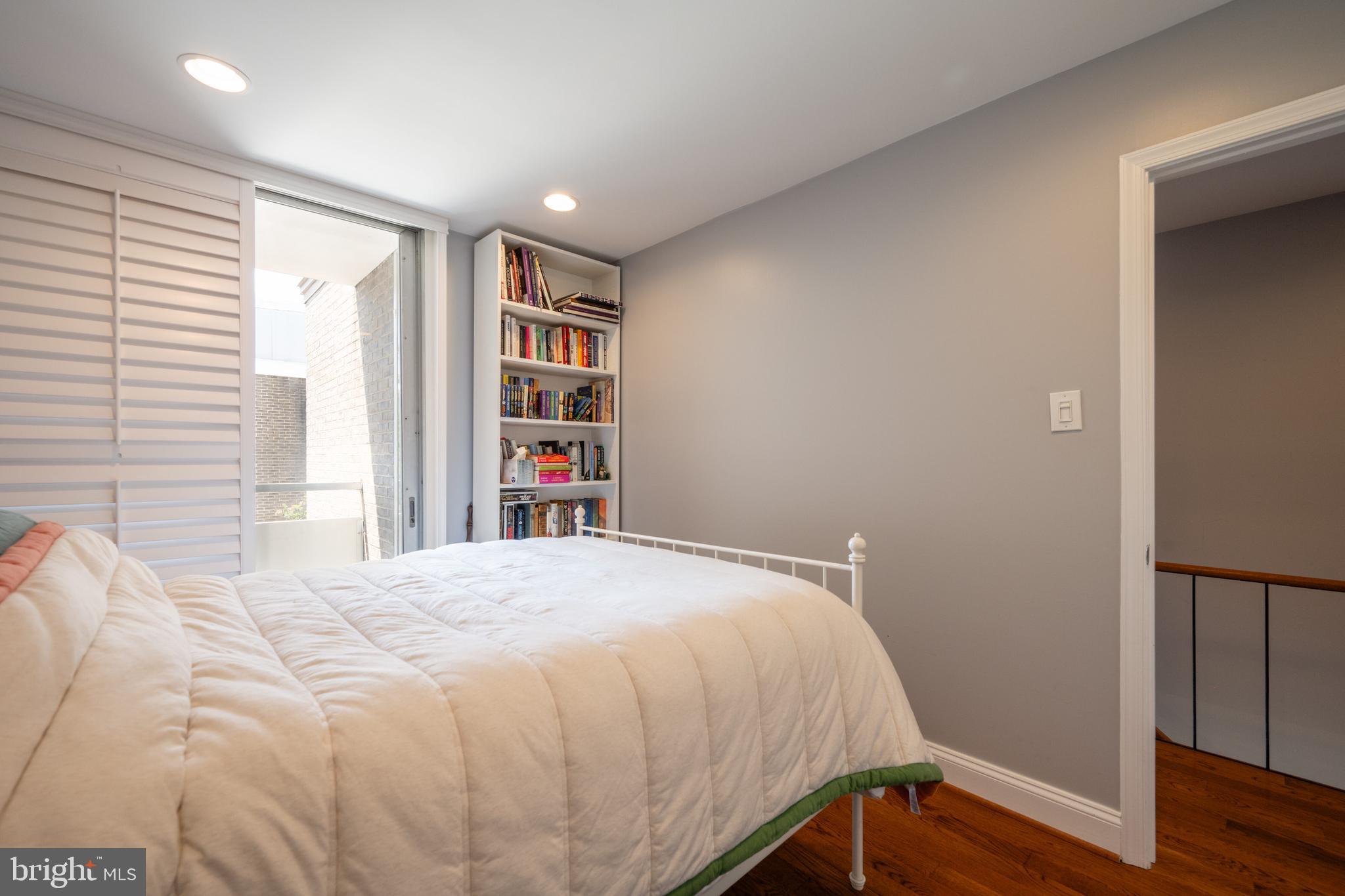 352 N Street Southwest Washington, DC 20024 - Photo 22 of 57 a bedroom with a bed and a book shelf