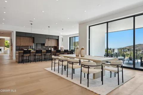 a living room with furniture and kitchen view