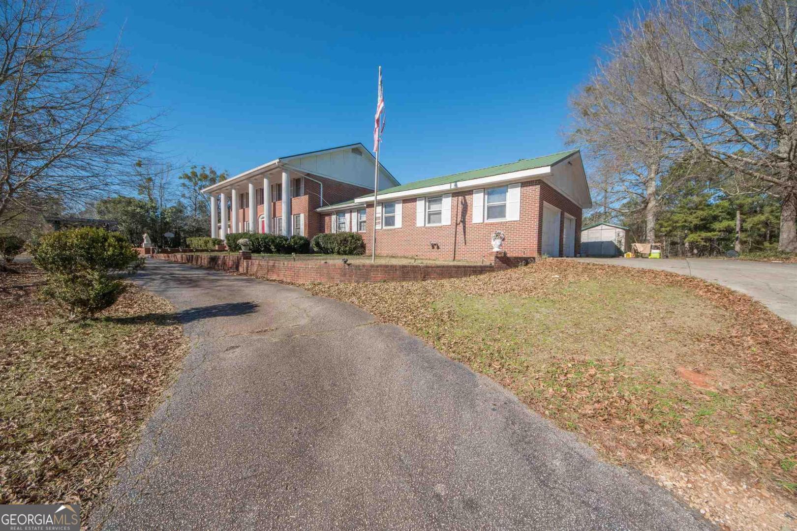 3861 Newnan Road Griffin, GA 30223 - Photo 2 of 89 a front view of a house with a dirt yard