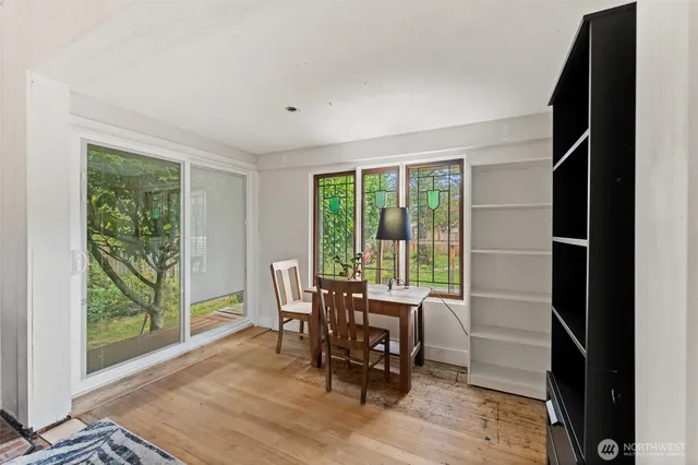 a dining room with furniture and wooden floor