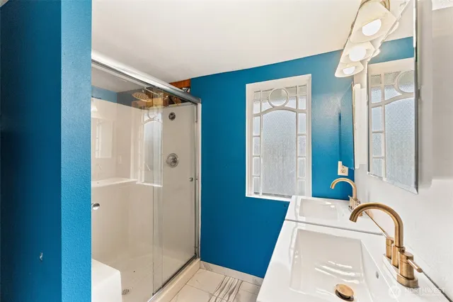 a bathroom with a tub shower and sink