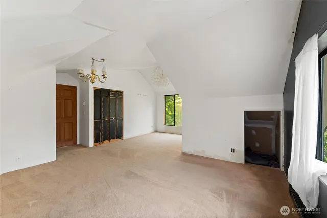 a view of a big room with windows and chandelier