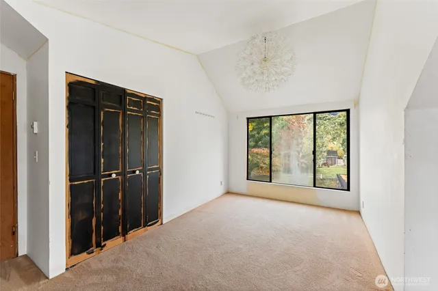 an empty room with windows and closet