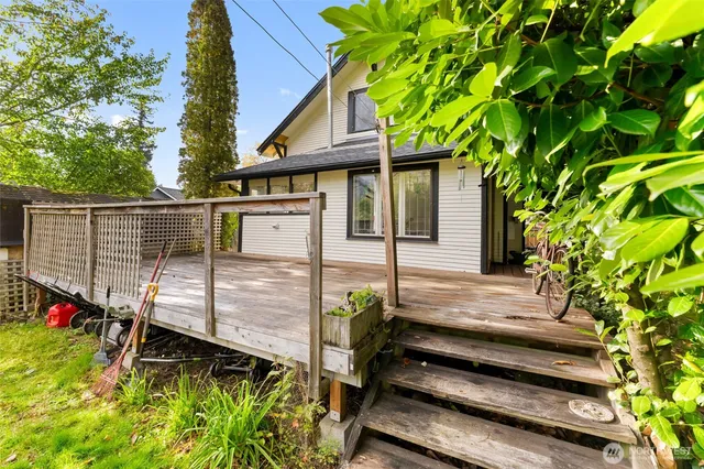 a view of a house with a wooden fence