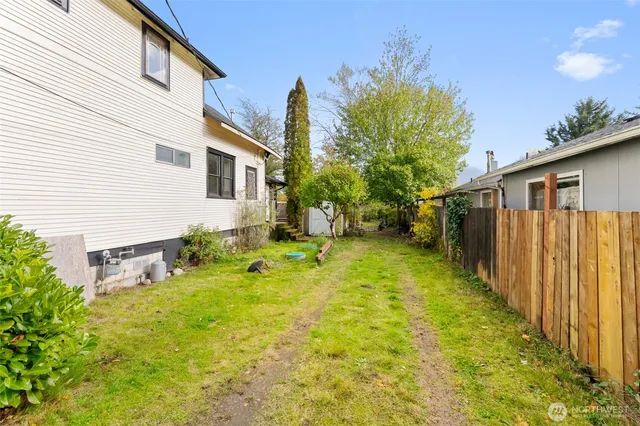 a view of a house with backyard and sitting area
