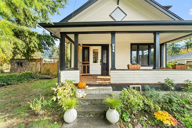 a view of a house with potted plants