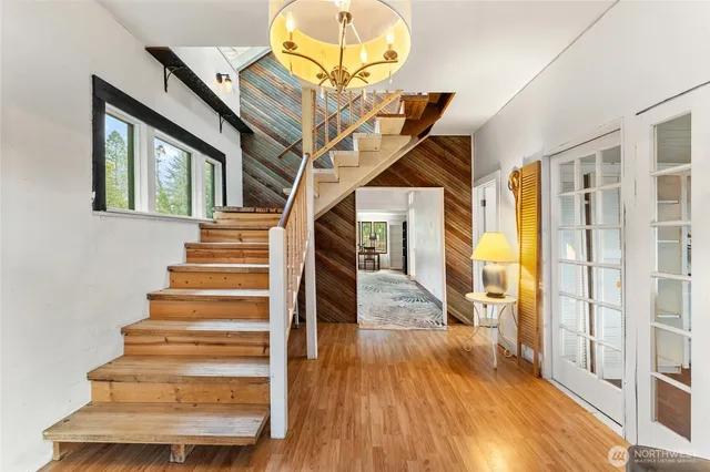 a view of entryway and hall with wooden floor