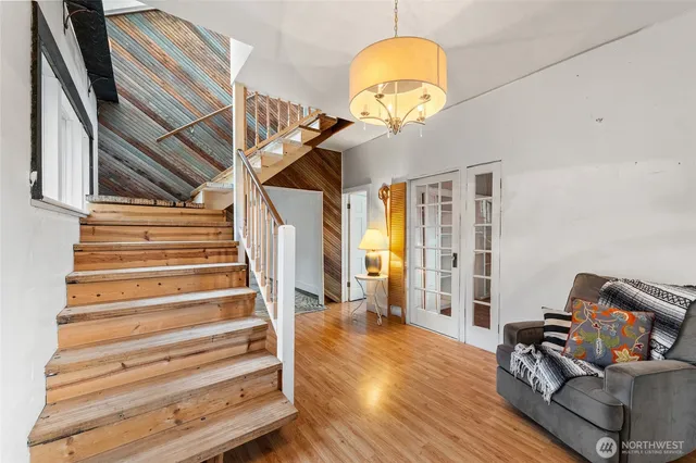 a view of entryway and hall with wooden floor