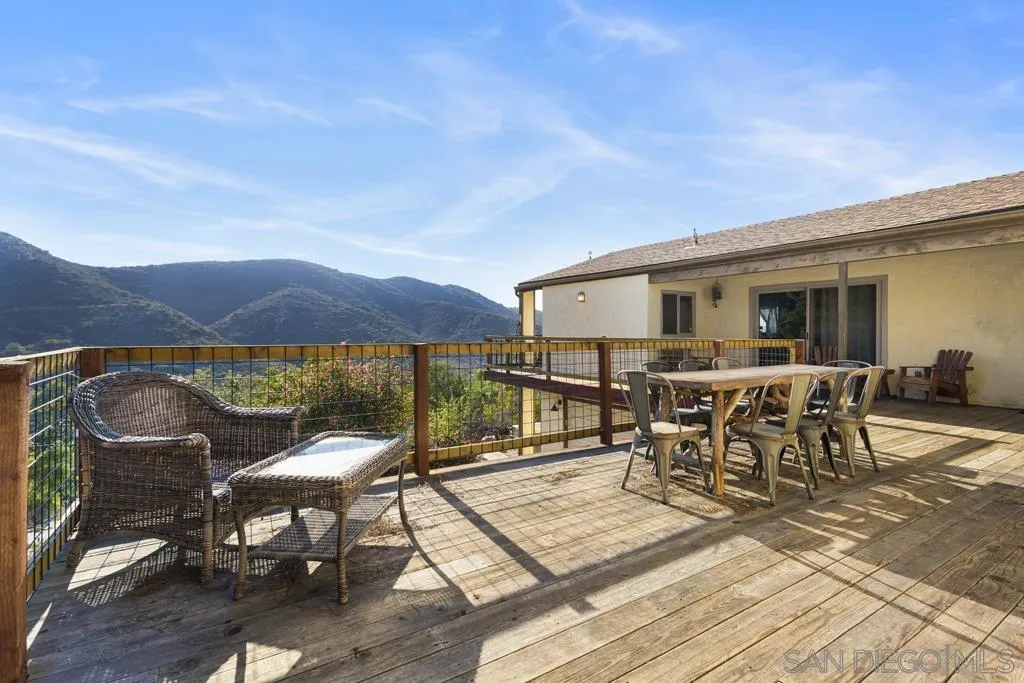 13492 Jamul Drive Jamul, CA 91935 - Photo 20 of 24 a view of a patio with table and chairs with wooden floor and fence