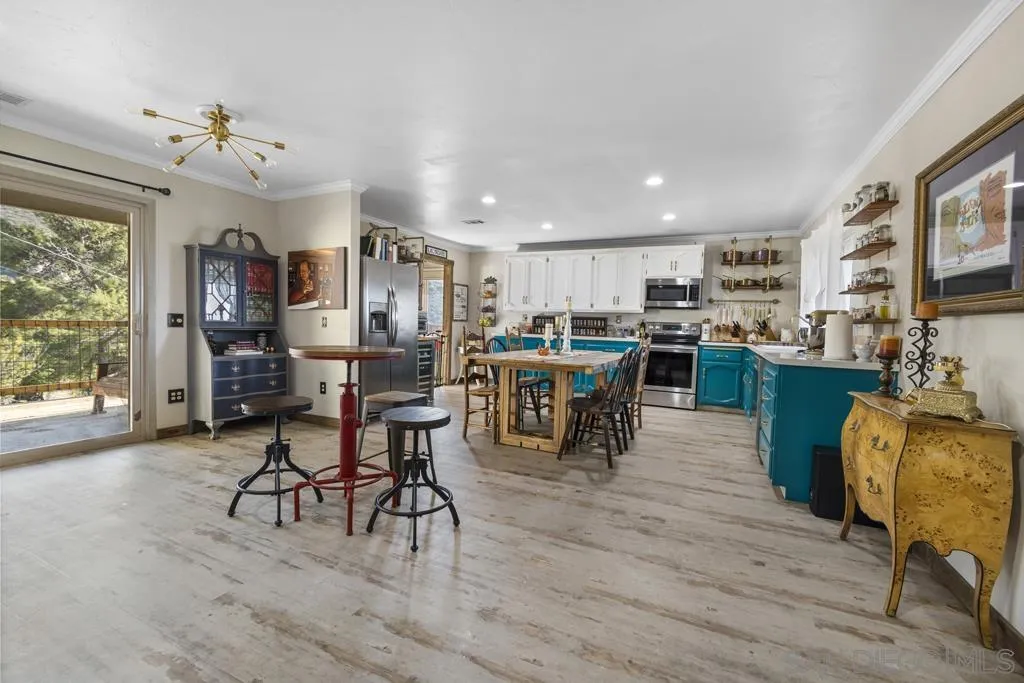 13492 Jamul Drive Jamul, CA 91935 - Photo 4 of 24 a living room with stainless steel appliances kitchen island granite countertop furniture and a dining table with kitchen view