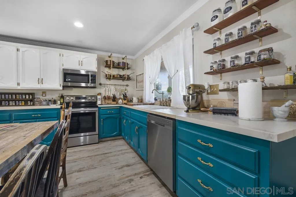 13492 Jamul Drive Jamul, CA 91935 - Photo 5 of 24 a kitchen with stainless steel appliances granite countertop a stove and a sink